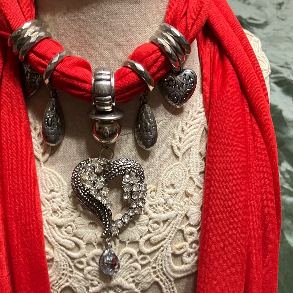 Vibrant red scarf necklace with a heart, pendant and silver toned beads